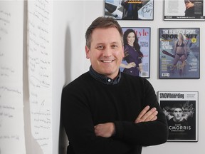 Russell Reimer, president of Manifesto Sports Management, in his Calgary home, with magazine covers featuring some of the athletes he represents.
