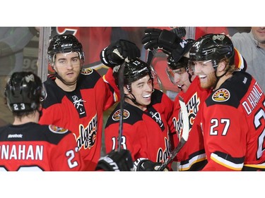 Dougie Hamilton of the Calgary Flames, right, celebrates his second period goal with, from the right, his brother Freddie, Johnny Gaudreau, TJ Brodie and Sean Monahan  against the Chicago Black Hawks at the Saddledome Saturday March 26, 2016.