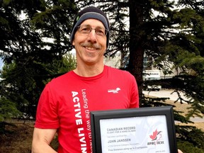 John Janssen with award certificate for setting Canadian hang gliding distance record.