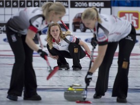Canada's Chelsea Carey, centre, watches her shot as lead Laine Peters and second Jocelyn Peterman sweep during the fifth draw against the United States at the Women's World Curling Championship in Swift Current, Sask. Sunday, March 20, 2016.