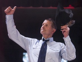 Kelly Sutherland salutes the crowd during the Canvas Auction at the Boyce Theatre in Calgary, Alta., on Thursday, March 17, 2016. Sutherland was among the highest bids among 36 drivers who would be part of the GMC Rangeland Derby during the Calgary Stampede in July.