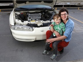 Chris Restall holds her three-year-old son Carter next to her newly repaired car, courtesy of Airdrie's Tools in Motion.