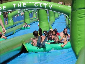 Calgarians embraced their inner child as they enjoyed the Slide the City event on 10th Street on Aug. 1, 2015.