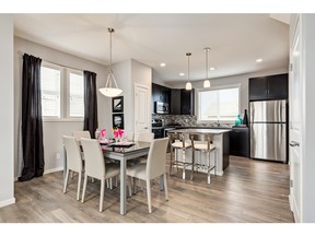 A look at the open-concept dining area and kitchen in the Bentley duplex by Homes by Avi in Auburn Bay.