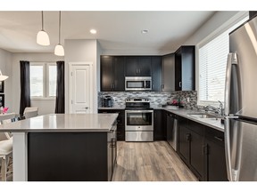 The kitchen in the Bentley duplex by Homes by Avi in the lake community of Auburn Bay.