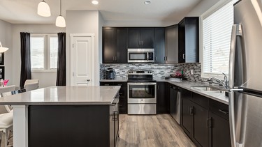 The kitchen in the Bentley duplex by Homes by Avi in the lake community of Auburn Bay.