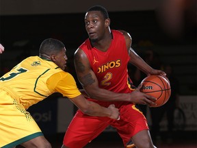U of C Dinos #2 Thomas Cooper looks to pass as  U of A's #3 Colby Jackson defends during Canada West Basketball playoffs at the Jack Simpson Gym Saturday night.  Photo by  David Moll, Dinos Athletics.