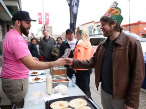 Calgary Herald reporter, right, is excited to taste a King of Donair from Halifax at their pop up shop  in Calgary, Ab., on Friday, March 4, 2016.
