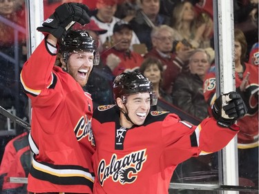 Dougie Hamilton celebrates scoring the Calgary Flames first goal with Johnny Gaudreau at the Scotiabank Saddledome in Calgary, Ab, on Saturday, March 26, 2016. The Flames lost the game 4-1 to the Chicago Blackhawks.