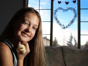 Natasha Gould, 12, plays with some baby chicks she has been caring for in her Calgary home on Tuesday March 8, 2016. Natasha had her dream of being a cheerleader cut short by a terminal brain cancer diagnosis last year.