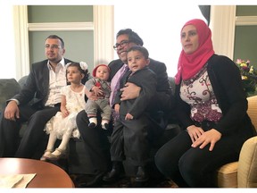 Emad Alsheblak, his wife Walaa, and their children Ghazal, 4, Ahmad, 2 and Omar, 3 months, pose with Calgary Mayor Naheed Nenshi at Calgary's city hall on Saturday, March 12, 2016, at a ceremony welcoming newcomers to Calgary. The family came from Daraa, Syria and arrived in January 2016.