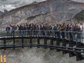 Employees of Heavy Industries who worked on the metal fabrication and railings of the Glacier Skywalk along the Icefields Parkway stand on the structure.
