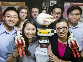Fourth-year mechanical engineering students Albert Buong, Sarah Johns, Crystal Quan, Brandon Rowsell, Sergie Angelo, Andrea Agudelo and Jediael Pagtalunan show off  their pediatric robot during the Shulich School of Engineering's Capstone Design Fair at the University of Calgary.