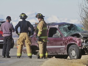 Emergency crews are pictured at the scene of a fatal crash on Dunbow Road east of 80th Street southeast of Calgary on Monday, March 7, 2016.