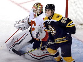 Boston Bruins center Noel Acciari (55) gets position against Calgary Flames goalie Joni Ortio (37) in the third period of an NHL hockey game, Tuesday, March 1, 2016, in Boston. (AP Photo/Elise Amendola)