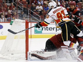 Calgary Flames' Sam Bennett gets sent flying into the air after he sends the puck past Arizona Coyotes goalie Louis Domingue for a goal during the Flames' 5-2 win in Arizona, Monday.