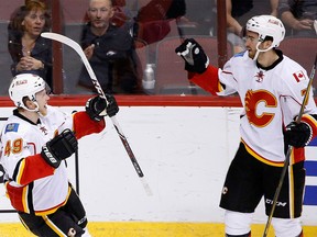 Calgary Flames' T.J. Brodie, right, celebrates his goal against the Arizona Coyotes with Hunter Shinkaruk (49) during the third period of an NHL hockey game Monday, March 28, 2016, in Glendale, Ariz.  The Flames defeated the Coyotes 5-2. (AP Photo/Ross D. Franklin)