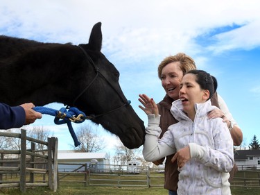 Jenny Seth, 35, feels a connection to horses, especially Diva, as her mom Lorraine Seth assists at Whispering Equine.