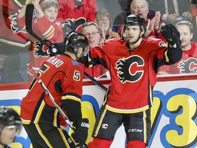 Michael Frolik of the Calgary Flames celebrates his shorthanded goal on the St. Louis Blues with teammate Mark Giordano during the Flames' 7-4 win in Calgary, Monday.
