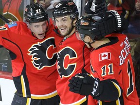 Calgary Flames Mason Raymond, left. celebrates his goal with Michael Frolik and Mikael Backlund against the New York Rangers in NHL hockey action at the Scotiabank Saddledome in Calgary on Saturday, Dec. 12, 2015.