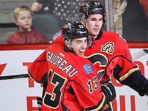 Calgary Flames Johnny Gaudreau and Sean Monahan celebrate after a goal by Jiri Hudler against the Anaheim Ducks during NHL hockey in Calgary on Monday, Feb. 15, 2016.