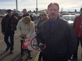 George Clark, organizer of the Albertans First campaign, called for opponents of the NDP government to actually join the provincial New Democratic Party at a gathering in the parking lot of Westbrook Mall on Feb. 19. (James Wood/Postmedia)