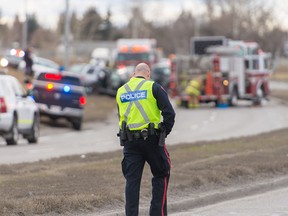 Police and EMS respond to a fatal collision involving multiple cars westbound on Glenmore Trail near the Crowchild overpass in Calgary on Sunday, March 27, 2016.