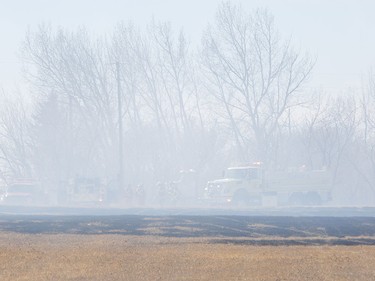 A grass fire southeast of Airdrie near Delacour grew and damaged at least one building and multiple vehicles. Crews had the fire under control by around 4 p.m. on Tuesday, March 29, 2016 in Airdrie, Alta.