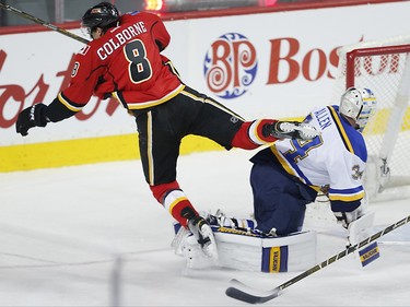 Calgary Flames Joe Colborne sails over goalie Jake Allen after scoring against the St. Louis Blues during NHL hockey in Calgary, Alta., on Monday, March 14, 2016. AL CHAREST/POSTMEDIA