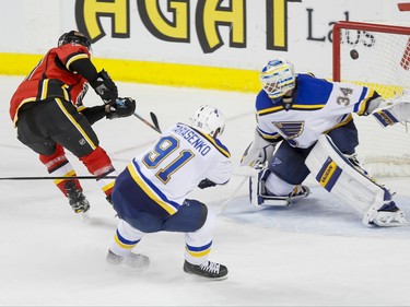 Michael Frolik of the Calgary Flames scores a shorthanded goal on St. Louis Blues goalie Jake Allen near Vladimir Tarasenko in Calgary, Alta., on Monday, March 14, 2016. Lyle Aspinall/Postmedia Network