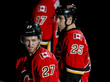 Brothers Dougie (L) and Freddie Hamilton of the Calgary Flames stand during the national anthem before action against the Winnipeg Jets in Calgary, Alta., on Wednesday, March 16, 2016. The Flames won 4-1. Lyle Aspinall/Postmedia Network