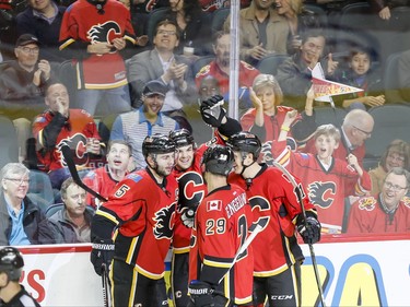 Michael Frolik of the Calgary Flames celebrates his shorthanded goal on the St. Louis Blues with teammates Mark Giordano, Deryk Engelland and Mikael Backlund in Calgary, Alta., on Monday, March 14, 2016. Lyle Aspinall/Postmedia Network