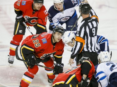 Freddie Hamilton of the Calgary Flames takes the opening faceoff against Adam Lowry of the Winnipeg Jets in Calgary, Alta., on Wednesday, March 16, 2016. The Flames won 4-1. Lyle Aspinall/Postmedia Network