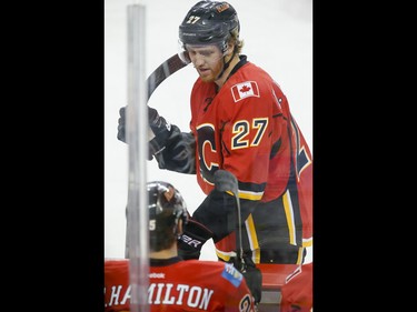 Dougie Hamilton of the Calgary Flames chats with his brother Freddie Hamilton during NHL action against the Winnipeg Jets in Calgary, Alta., on Wednesday, March 16, 2016. The Flames won 4-1. Lyle Aspinall/Postmedia Network