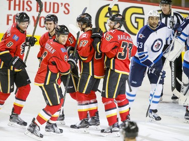 The Calgary Flames celebrate a first-period goal on the Winnipeg Jets in Calgary, Alta., on Wednesday, March 16, 2016. The Flames won 4-1. Lyle Aspinall/Postmedia Network