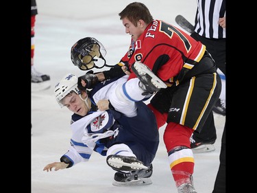 JC Lipon of the Winnipeg Jets fights Michael Ferland of the Calgary Flames during NHL hockey in Calgary, Alta., on Wednesday, March 16, 2016. AL CHAREST/POSTMEDIA