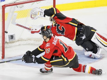 Calgary Flames goalie Joni Ortio can't dive fast enough for a St. Louis Blues goal near teammate Mikael Backlund in Calgary, Alta., on Monday, March 14, 2016. Lyle Aspinall/Postmedia Network
