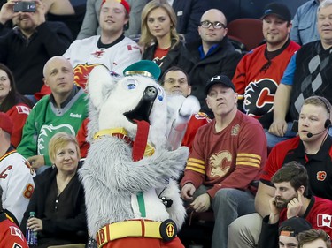 Calgary Flames mascot Harvey the Hound launches a T-shirt into the crowd during NHL action against the Winnipeg Jets in Calgary, Alta., on Wednesday, March 16, 2016. The Flames won 4-1. Lyle Aspinall/Postmedia Network