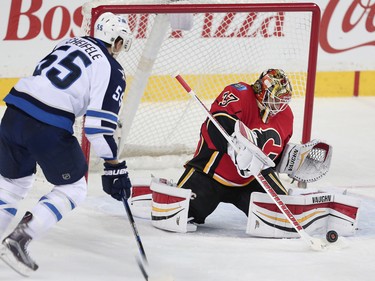 Calgary Flames Joni Ortio with save against the Winnipeg Jets during NHL hockey in Calgary, Alta., on Wednesday, March 16, 2016. AL CHAREST/POSTMEDIA