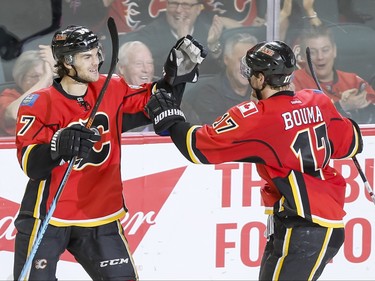 Michael Frolik of the Calgary Flames celebrates his second shorthanded goal on the St. Louis Blues with teammate Lance Bouma in Calgary, Alta., on Monday, March 14, 2016. Lyle Aspinall/Postmedia Network