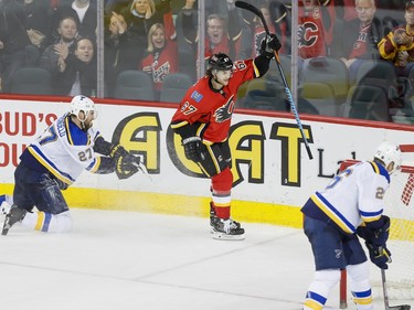 Michael Frolik of the Calgary Flames celebrates his empty-net goal to complete his hat-trick near Alex Pietrangelo and Paul Stastny of the  St. Louis Blues in Calgary, Alta., on Monday, March 14, 2016. Lyle Aspinall/Postmedia Network