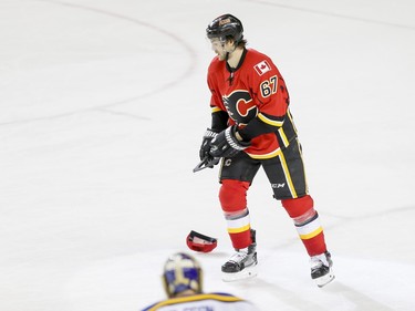 Michael Frolik of the Calgary Flames eyes a hat thrown in his honour against the St. Louis Blues in Calgary, Alta., on Monday, March 14, 2016. The Flames won 7-4. Lyle Aspinall/Postmedia Network