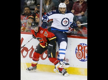 Lance Bouma of the Calgary Flames collides with Dustin Byfuglien of the Winnipeg Jets in Calgary, Alta., on Wednesday, March 16, 2016. The Flames won 4-1. Lyle Aspinall/Postmedia Network
