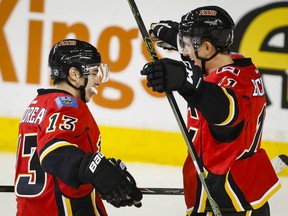 Calgary Flames' Mikael Backlund, right, from Sweden, celebrates his game-winning goal with teammate Johnny Gaudreau following overtime NHL hockey action against the Nashville Predators in Calgary, Wednesday, March 9, 2016.