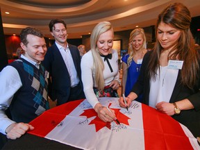 Left to right: Athletes Kyle Shewfelt, Shane Doan, Kaillie Humphries, Bailey Bram and Rebecca Johnston sign a flag at the Classroom Champions Live Speaker series, where top athletes will discuss the importance of mentorship both on and off the ice. (Mike Drew/Postmedia)
