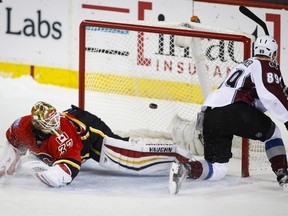 Colorado Avalanche's Mikkel Boedker, right, of Denmark, scores the game-winning goal on Calgary Flames' goalie Joni Ortio, from Finland, during a shootout in overtime NHL hockey action in Calgary on Friday, March 18, 2016.THE CANADIAN PRESS/Jeff McIntosh ORG XMIT: JMC111