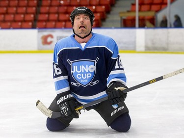 Tenor and guitarist Remigio Pereira feels himself falling while trying to pull a requested sliding air guitar before a Juno Cup practice game at Max Bell Centre in Calgary, Alta., on Thursday, March 31, 2016. Musicians and former NHLers were prepping for the Juno Cup hockey game set for this Friday, part of events leading up to the Juno Awards on Sunday at the Saddledome. Lyle Aspinall/Postmedia Network