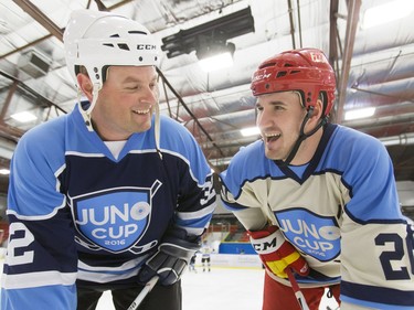 Former Calgary Flames player Curtis Glencross (R) mugs for a photo with his musician pal Gord Bamford before a Juno Cup practice game at Max Bell Centre in Calgary, Alta., on Thursday, March 31, 2016. Musicians and former NHLers were prepping for the Juno Cup hockey game set for this Friday, part of events leading up to the Juno Awards on Sunday at the Saddledome. Lyle Aspinall/Postmedia Network