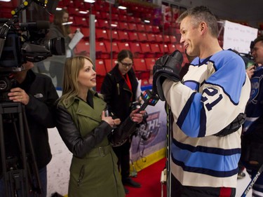 Former Calgary Flames player Perry Berezan speaks with CTV before a Juno Cup practice game at Max Bell Centre in Calgary, Alta., on Thursday, March 31, 2016. Musicians and former NHLers were prepping for the Juno Cup hockey game set for this Friday, part of events leading up to the Juno Awards on Sunday at the Saddledome. Lyle Aspinall/Postmedia Network