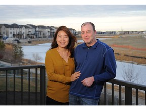 Kathy Cho and Darren Swann with the canals behind their home in Bayside.